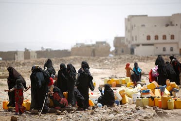 Women and children fill buckets with water from a public tap amid an acute shortage of water, on the outskirts of Sanaa. (File photo: AP)