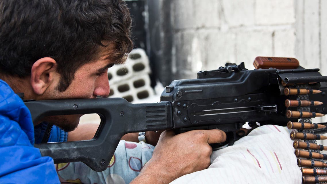 n this Wednesday, Nov. 19, 2014, file photo, a young Kurdish People's Protection Units (YPG) fighter who recently volunteered, holds a position with a PKM in Kobani, Syria. AP