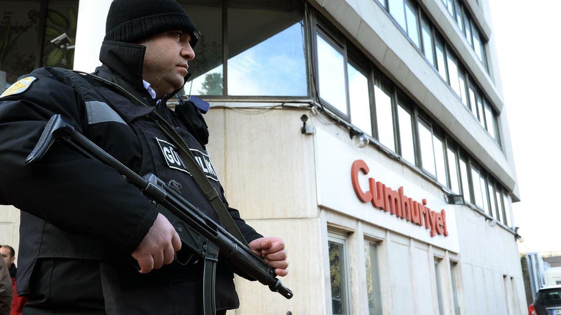 A police officer stands guard at the entrance of Cumhuriyet, the leading pro-secular Turkish newspaper, in Istanbul, Turkey, Wednesday, Jan. 14, 2015. Cumhuriyet said police stopped trucks as they left its printing center to check the paper's content after it decided to print a selection of Charlie Hebdo caricatures. Cumhuriyet said police allowed distribution of the newspaper to proceed on Wednesday after verifying that the satirical French newspaper's controversial cover featuring the Prophet Muhammad was not published. (AP Photo)