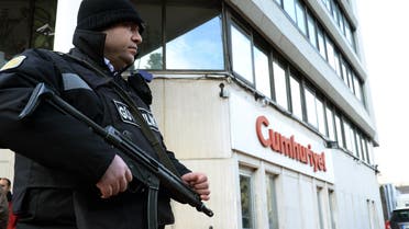  A police officer stands guard at the entrance of Cumhuriyet, the leading pro-secular Turkish newspaper, in Istanbul, Turkey, Wednesday, Jan. 14, 2015. Cumhuriyet said police stopped trucks as they left its printing center to check the paper's content after it decided to print a selection of Charlie Hebdo caricatures. Cumhuriyet said police allowed distribution of the newspaper to proceed on Wednesday after verifying that the satirical French newspaper's controversial cover featuring the Prophet Muhammad was not published. (AP Photo)