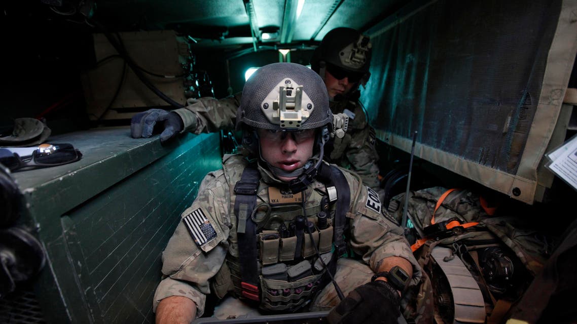 U.S. Army Specialist Chris Brann of the 737 Explosive Ordnance Disposal (EOD) Company operates a robot by remote as he searches for an IED (improvised explosive device) during a road clearance patrol in Logar province, eastern Afghanistan November 23, 2011. (Reuters)
