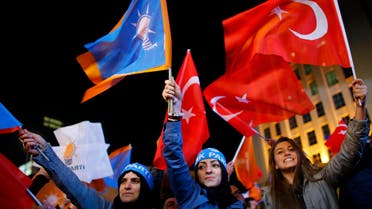 Women wave flags outside the AK Party headquarters in Ankara, Turkey November 1, 2015. REUters