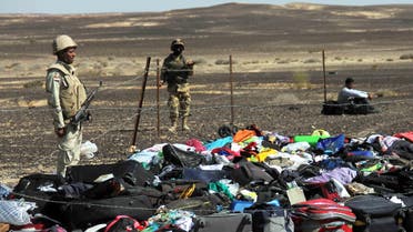 Egyptian Army soldiers stand near luggage and personal effects of passengers a day after a passenger jet bound for St. Petersburg, Russia crashed in Hassana, Egypt, on Sunday, Nov. 1, 2015. (AP)
