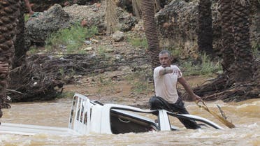 A man gestures as he tries to save a vehicle swept away by flood waters in Yemen's island of Socotra November 2, 2015. A rare tropical cyclone packing hurricane-force winds killed three people and injured scores on the Yemeni island of Socotra on Monday, residents and officials said. REUTERS/Stringer EDITORIAL USE ONLY. NO RESALES. NO ARCHIVE TPX IMAGES OF THE DAY