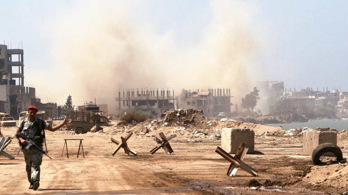 A Lebanese soldier patrols the entrance of the Palestinian refugee camp of Nahr el-Bared as smoke rises from the destruction of unexploded shells, mines and other explosives left behind by Fatah Islam militants in Tripoli, Lebanon Friday, Sept. 7, 2007. (AP)