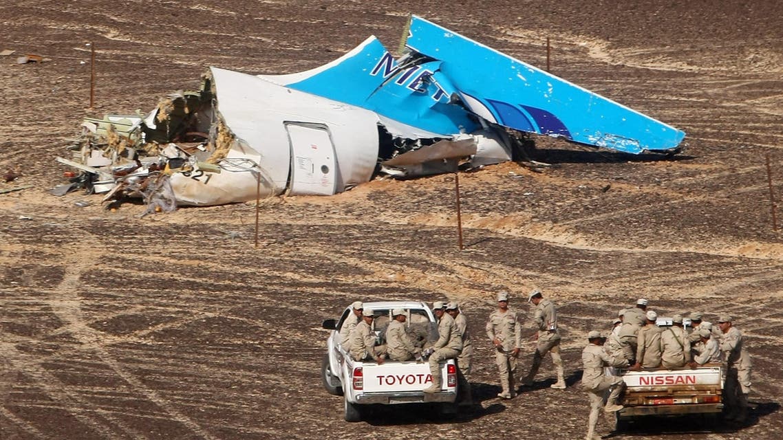 In this photo made available Monday, Nov. 2, 2015, and provided by Russian Emergency Situations Ministry, Egyptian Military on cars approach a plane's tail at the wreckage of a passenger jet bound for St. Petersburg in Russia that crashed. (AP)