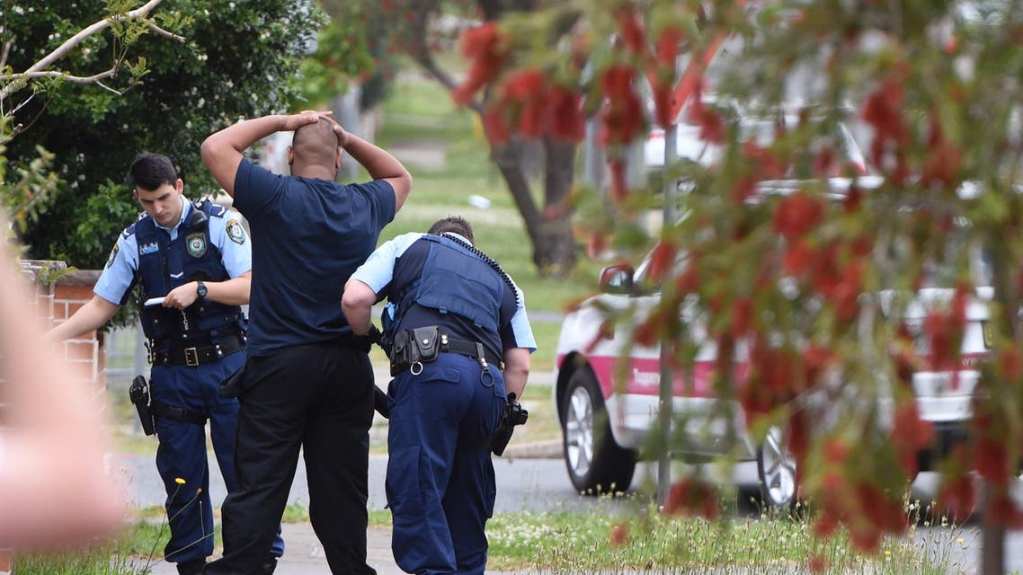  Police pull over and search a man and his vehicle near a house which was raided earlier Wednesday morning on Bursill Street at Guildford in Sydney's west, Oct. 7, 2015. Police arrested five people during a series of raids on Wednesday in connection with the slaying of a civilian police worker, which officials have said they believe was linked to terrorism. (Dean Lewins/AAP Image via AP) NO ARCHIVING, AUSTRALIA OUT, NEW ZEALAND OUT, PAPUA NEW GUINEA OUT, SOUTH PACIFIC OUT