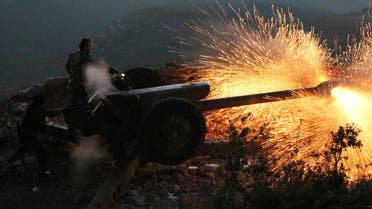 In this photo taken on Saturday, Oct. 10, 2015, Syrian army personnel fire a cannon in Latakia province, about 12 from the border with Turkey in Syria.  (AP)