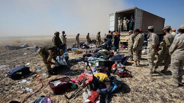  Egyptian soldiers collect personal belongings of plane crash victims at the crash site of a passenger plane bound for St. Petersburg in Russia that crashed in Hassana, Egypt's Sinai Peninsula. (AP)