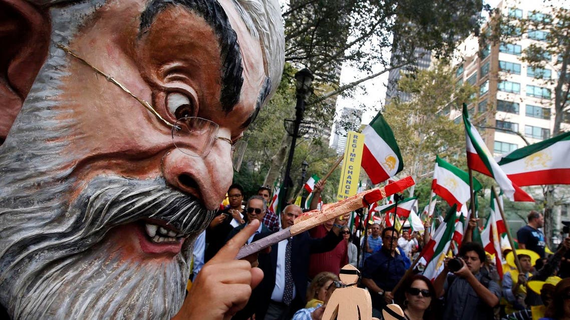 A protester wearing a large mask bearing the likeness of Iranian President Hassan Rouhani attends an anti-Rouhani rally outside United Nations headquarters ahead of the leader's address to the 70th session of the U.N. General Assembly. (AP)