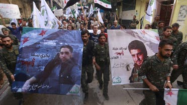 Free Syrian Army fighters and residents carry pictures of Free Syrian Army commander Abu Khaled Aziza (R) and fighter Bakri Sakka, who both died fighting Islamic state fighters in the northern countryside of Aleppo, during a march to mourn their deaths in Aleppo, Syria October 16, 2015. REUTERS/Hosam KatanFOR EDITORIAL USE ONLY. NO RESALES. NO ARCHIVE.