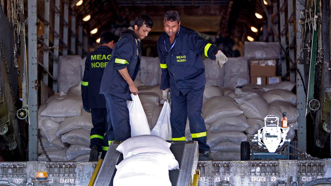 Workers unload emergency aid sent from Russia, at the Rafik Hariri International Airport in Beirut, Lebanon, Wednesday, April 3, 2013. AO