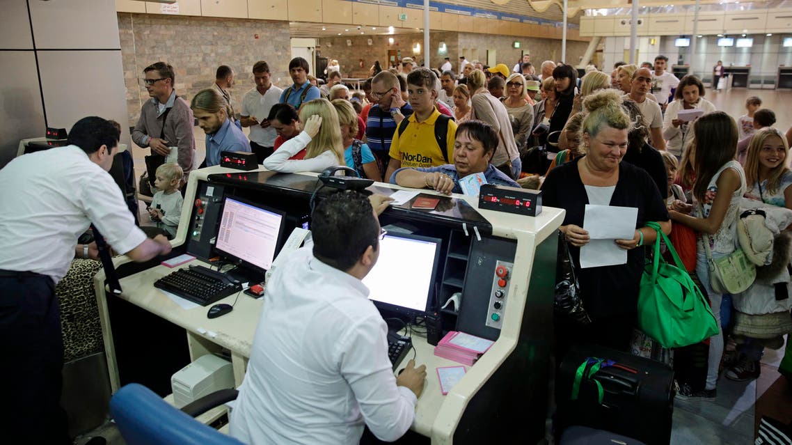 Russian tourists check in as they prepare to depart for St.Petersburg, Russia from Sharm el-Sheikh International Airport, south Sinai, Egypt, Thursday, Nov. 5, 2015.