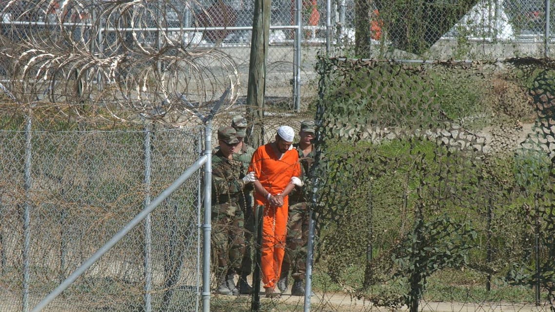 In this March 1, 2002 file photo, a detainee is escorted to interrogation by U.S. military guards at Camp X-Ray at Guantanamo Bay U.S. Naval Base, Cuba. Three detainees from Guantanamo Bay have been transferred from the island prison to the country of Georgia. (AP)