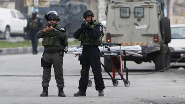 Israeli border police point their weapon as they guard at the scene where a Palestinian woman shot dead by Israeli troops in the West Bank city of Hebron November 6, 2015. (Reuters)