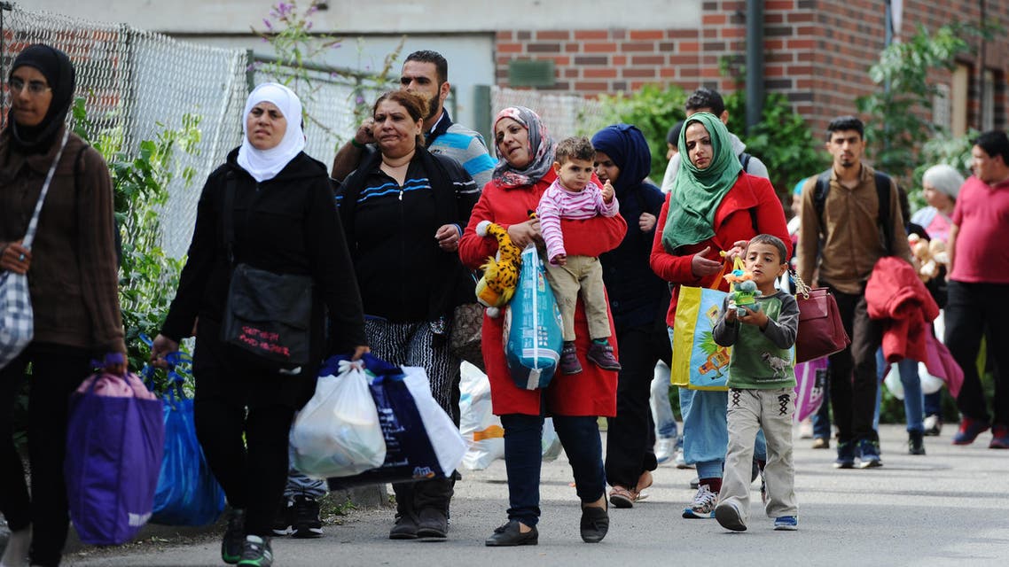 Migrants and refugees arrive at a tent village at the Donnersberg bridge close to the central train station in Munich, Germany, Sunday Sept. 13, 2015 .