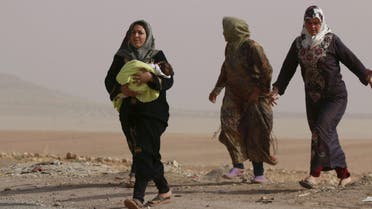 Internally displaced women who fled the violence in Abteen village walk along a street in Mraykes village in the southern countryside of Aleppo, Syria October 21, 2015. Fighting in Syria has displaced 35,000 people from Hader and Zerbeh on the southwestern outskirts of the city of Aleppo in the past few days, the U.N. Office for the Coordination of Humanitarian Affairs (OCHA) said on Monday. REUTERS/Hosam Katan FOR EDITORIAL USE ONLY. NO RESALES. NO ARCHIVE.