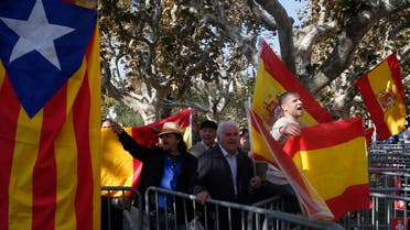 People hold Spanish flags next to an "estelada" or pro-independence flag, outside parliament in Barcelona, Spain, Monday, Nov. 9, 2015. AP 