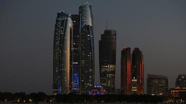 The Etihad Towers, left, are lit in the blue hues of the United Nation's logo in celebration of the U.N.'s 70th anniversary, in Abu Dhabi, United Arab Emirates, Oct. 24, 2015. (AP)