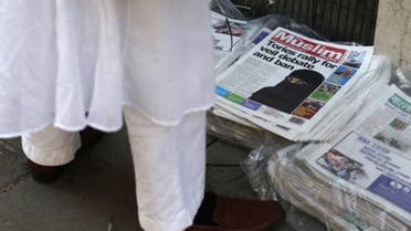 A man looks at newspapers outside the Brick Lane Jamme Masjid (mosque) before Friday prayers in east London. (File photo: Reuters)