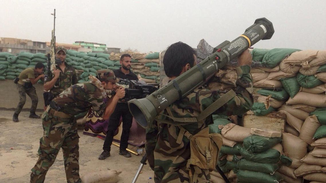 In this Oct. 30, 2015 photo Iraqi security forces take combat position at the front-line with Islamic State group militants in the eastern suburbs of Ramadi, Anbar province, Iraq. (AP Photo)