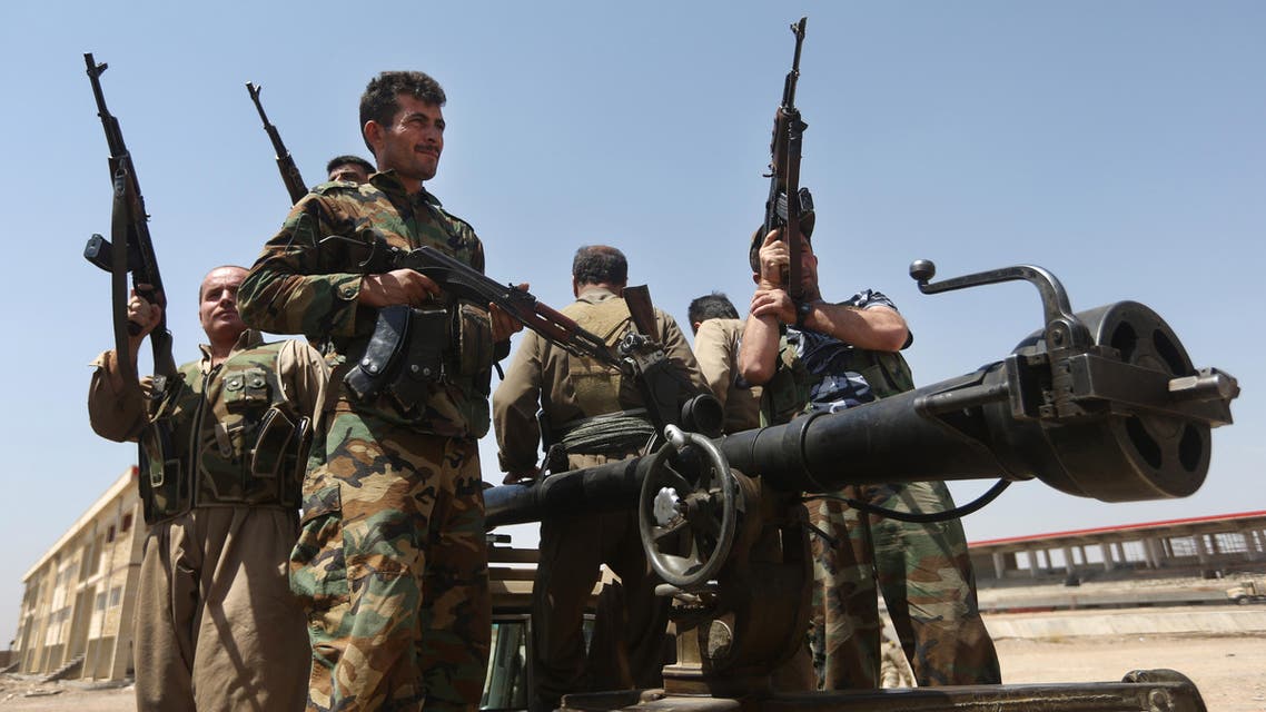 In this Wednesday, June 25, 2014 file photo, Kurdish peshmerga fighters take positions on the front line with militants from the al-Qaida-inspired Islamic State in Iraq and the Levant (ISIL), in Tuz Khormato, 100 kilometers (62 miles) south of the oil rich province of Kirkuk, northern Iraq.