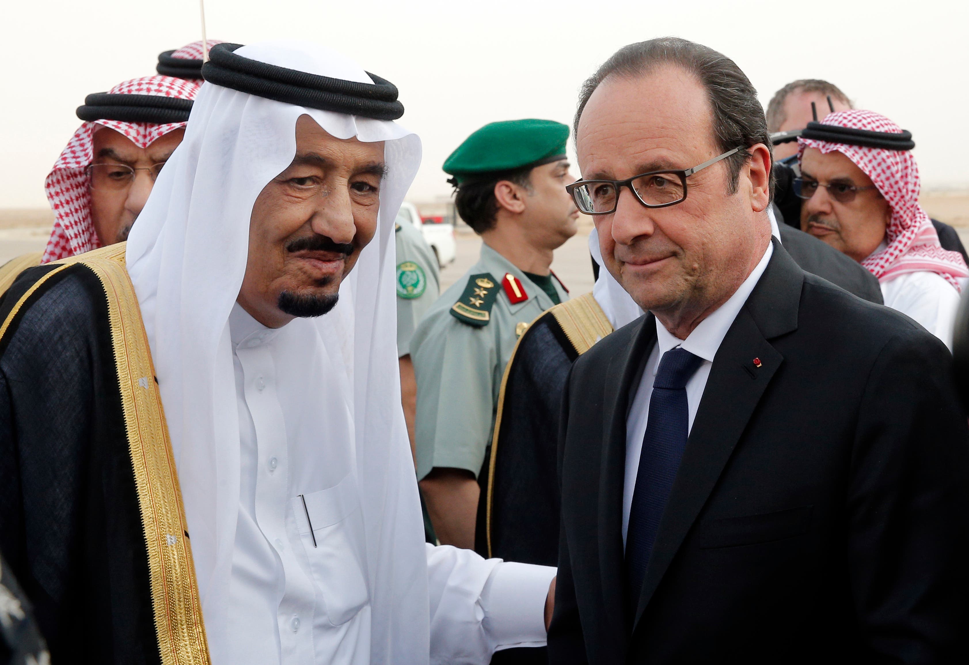  French President Francois Hollande, right, is greeted by Saudi Arabia’s King Salman upon his arrival at Riyadh airport, Saudi Arabia, Monday, May 4, 2015. Hollande is the guest of honor of the Gulf cooperation council summit in Riyadh, where security issues in the region are going to be discussed. (AP Photo/Christophe Ena, Pool)