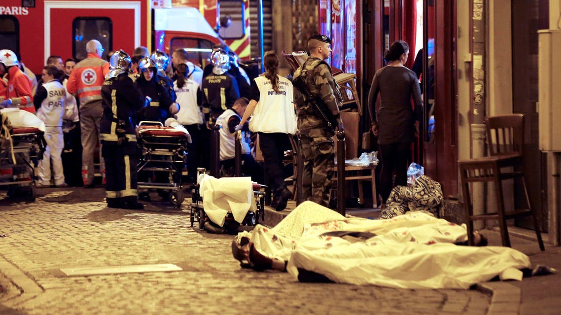 A soldier stands by victims in the10th district of Paris, Friday, Nov. 13, 2015. (AP)