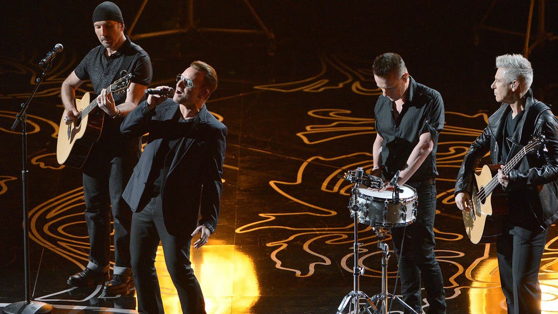 The Edge, from left, Bono, Larry Mullen, Jr. and Adam Clayton of U2 perform on stage during the Oscars at the Dolby Theatre on Sunday, March 2, 2014, in Los Angeles.