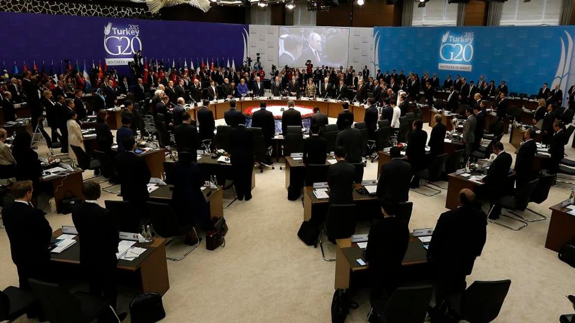 World leaders hold a minute of silence for the victims of Paris attacks prior to the opening session of the G-20 summit, in Antalya, Turkey, Sunday, Nov. 15, 2015. The 2015 G-20 Leaders Summit is held near the Turkish Mediterranean coastal city of Antalya on Nov. 15-16, 2015. (Anadolu Agency via AP, Pool)