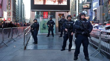 Heavily armed New York city police officers with the Strategic Response Group stand guard at the armed forces recruiting center in New York's Times Square, Saturday, Nov. 14, 2015. 