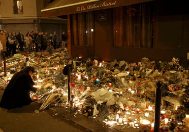 People gather outside Le Carillon restaurant, one of the attack sites in Paris, November 15, 2015. REUTERS/Jacky Naegelen
