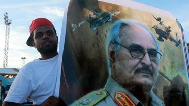 A man holds a picture of General Khalifa Haftar during a demonstration in support of the Libyan army. (File photo: Reuters)