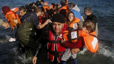 A migrant man holding a child reacts as refugees and migrants arrive on the Greek island of Lesbos. (File photo: Reuters)