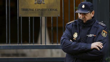 A Spanish National Police officer stands in the entrance of Spanish Constitutional Court in Madrid, Spain, November 11, 2015. Spanish Prime Minister Mariano Rajoy said on Wednesday his government had filed an appeal with the Constitutional Court in a bid to block an independence drive by Catalonia region's local assembly and preserve Spanish national unity. REUTERS/Sergio Perez
