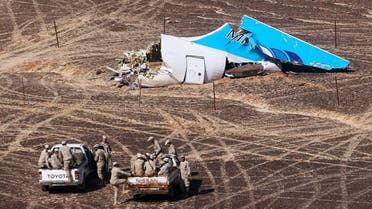 Russian Emergency Situations Ministry, Egyptian Military on cars approach a plane's tail at the wreckage of a passenger jet bound for St. Petersburg in Russia that crashed in Hassana, Egypt. (File photo: AP)