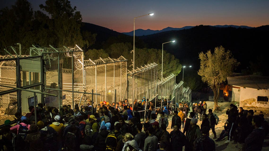 Refugees and migrants wait to enter a registration center in Moria village on the northeastern Greek island of Lesbos,, Tuesday, Nov. 17, 2015. European leaders pressed ahead with efforts to discourage people from heading to Europe to find work and kept seeking ways to send back home thousands who don't qualify for asylum. (AP Photo/Santi Palacios)