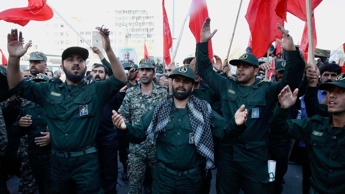 A group of Iranian Revolutionary Guard members mourn during the funeral ceremony of Gen. Hossein Hamedani in Tehran, Iran, Sunday, Oct. 11, 2015. Hamedani, a senior commander of the Guard, was killed by Islamic State extremists last week near the Syrian city of Aleppo, according to a state TV report. (AP Photo/Vahid Salemi)