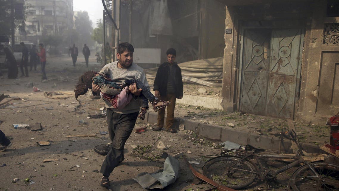 A man carries an injured girl as he rushes away from a site hit by what activists said were airstrikes by forces loyal to Syria's President Bashar al-Assad, in the Douma neighborhood of Damascus, Syria November 7, 2015. REUTERS/Bassam Khabieh TPX IMAGES OF THE DAY