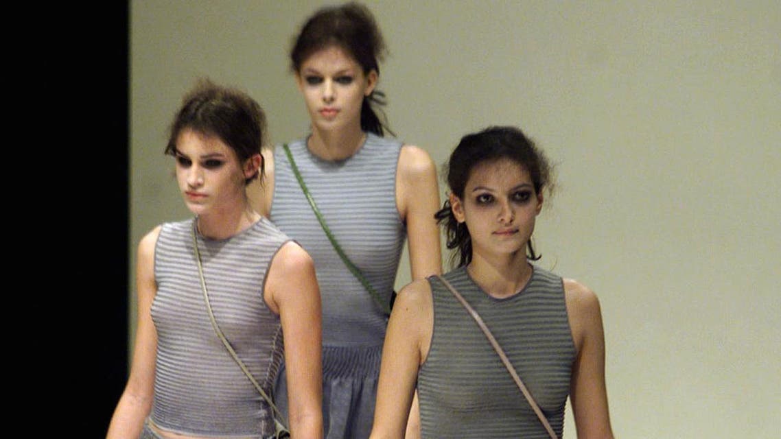 Models present grey dresses as part of the Giorgio Armani's autumn/winter 1999-2000 collection at Milan's fashion show March 3.