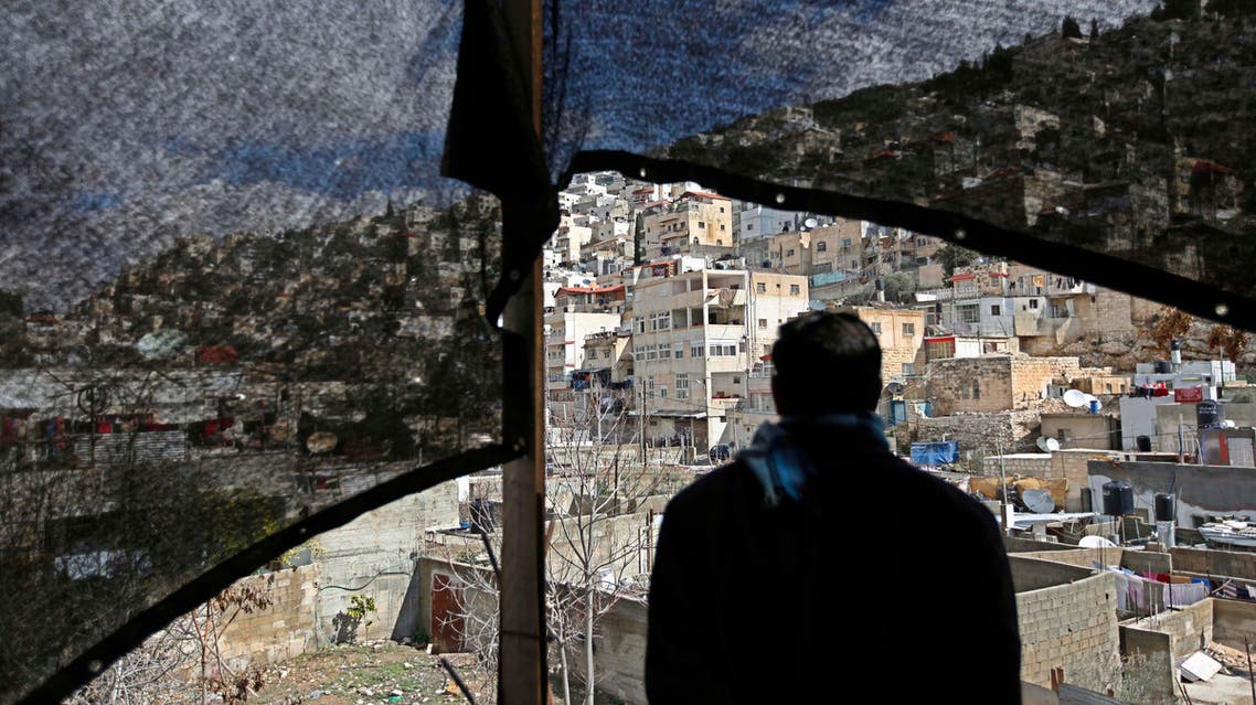 A Palestinian man looks out over the neighborhood of Silwan in Jerusalem, Monday, Feb. 23, 2009. Just outside the Old City walls in east Jerusalem and near the city's holiest shrines for Jews and Muslims, the ramshackle Arab neighborhood of Silwan stands atop a site Israelis call the City of David, named for the Biblical monarch who ruled a Jewish kingdom from the spot 3,000 years ago. The Israeli government has designated the area an archaeological park whose expansion the Arab homes limit. Arab residents say they owned the land before Israel occupied east Jerusalem in 1967 and consider the demolition orders an effort to diminish their presence in the capital of a hoped-for Palestinian state. (AP Photo/Tara Todras-Whitehill)