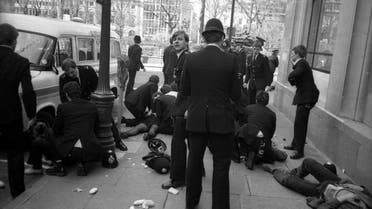 Police officers surround police constable Yvonne Fletcher after she was shot during a protest against Libyan leader Colonel Muammar Gaddafi in London, in this file photograph dated April 17, 1984. British police said they had arrested a Libyan man on November 19, 2015 for the 1984 murder of Fletcher who was shot dead outside the Libyan embassy in London. REUTERS/Clive Challis/files