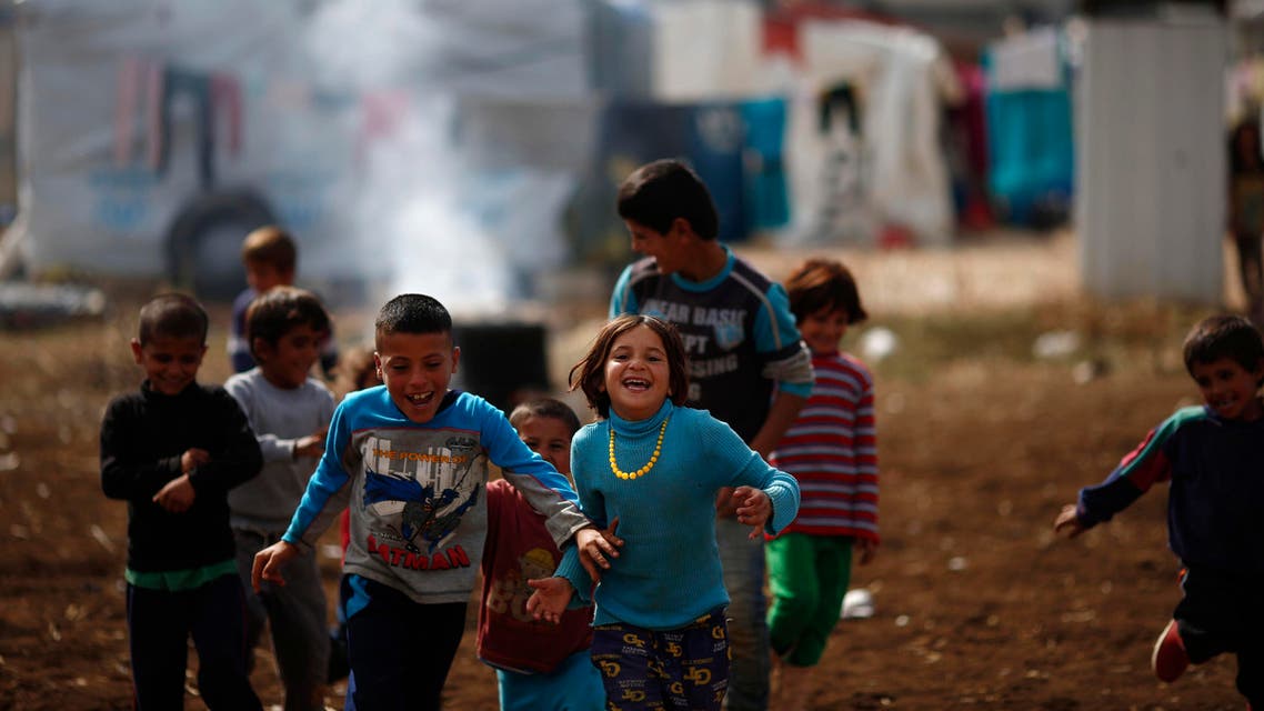 Syrian refugee boys play at a refugee camp in the town of Hosh Hareem, in the Bekaa valley, east Lebanon, Wednesday, Oct. 28, 2015. The United Nations said Tuesday the worsening conflict in Syria has left 13.5 million people in need of aid and some form of protection, including more than six million children. (AP Photo/Hassan Ammar)