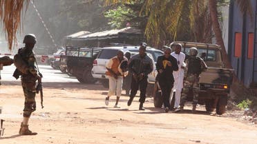 People run to flee from the Radisson Blu Hotel in Bamako, Mali, Friday, Nov. 20, 2015. (AFP)
