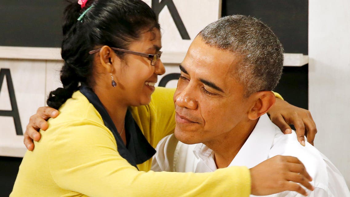 Obama gets a thank-you hug from a refugee as he tours the Dignity for Children Foundation in Kuala Lumpur. (Reuters)
