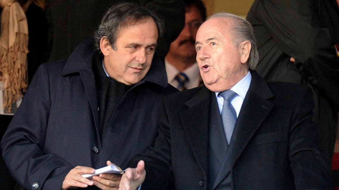 UEFA president Michel Platini, left, talks with FIFA president Sepp Blatter, right, in this file photo dated Friday, June 18, 2010,