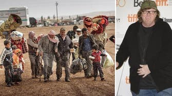 9/11 filmmaker Michael Moore opens home to Syrian refugees 