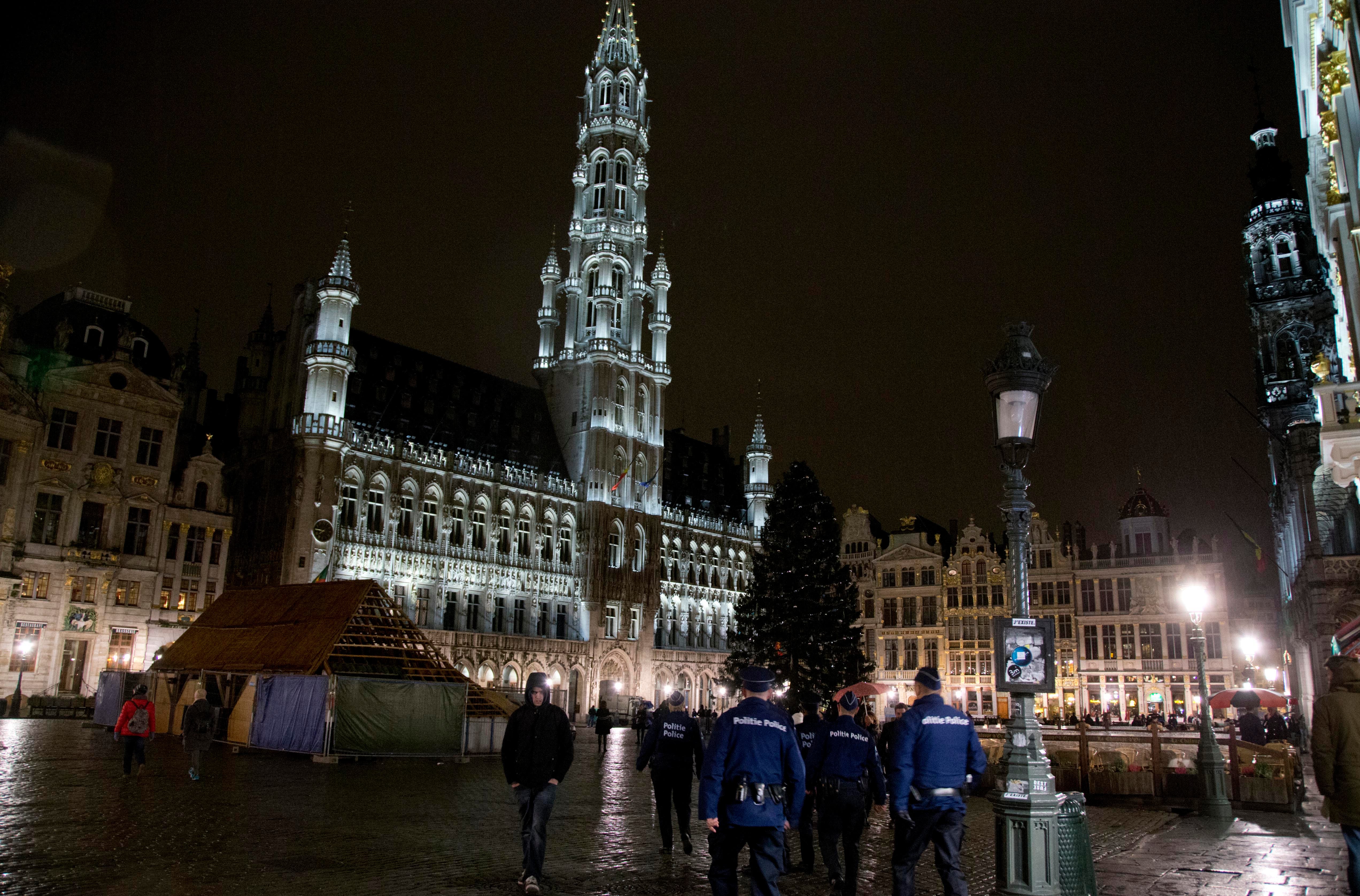  Police patrol in the Grand Place in the center of Brussels on Saturday, Nov. 21, 2015. Belgium raised its security level to the highest degree on Saturday as the manhunt continues for extremist Salah Abdeslam who took part in the Paris attacks. The security alert shut metro's, shops, and cancelled events with high concentrations of people. (AP Photo/Virginia Mayo)