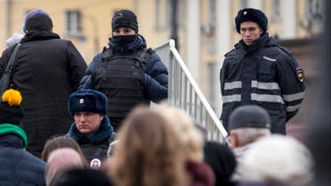  Russian police officers watch people as they line for an exhibition, in Manezh Square outside the Kremlin in Moscow, Russia, Friday, Nov. 20, 2015. In reaction to the recent attacks in France, Russian security forces across the country, are introducing additional measures to strengthen security. (AP Photo/Pavel Golovkin)