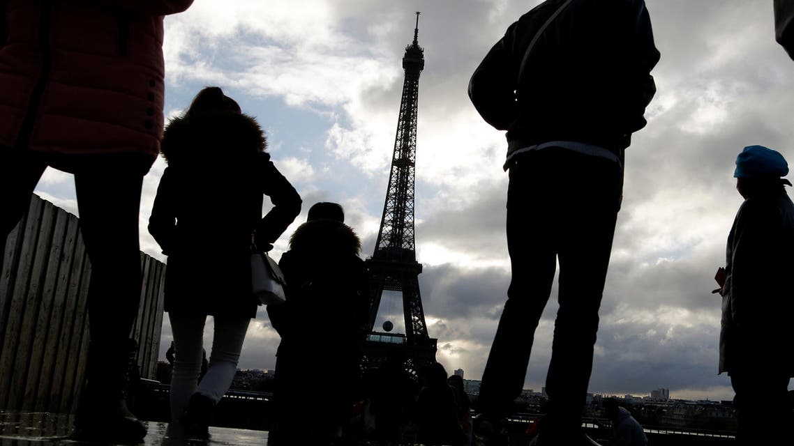 People look at the Eiffel tower from the Trocadero place a week after the start of the Paris attacks, in Paris, Saturday, Nov. 21, 2015 (AP)
